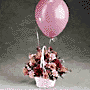 A variety flowers in a white basket with 2 latex balloons. Flowers may included Delphinium, Pompons, Alstroemeria and Carnations.