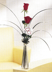 bud vase with two red roses in a beautiful metal keepsake container with greens and fillers