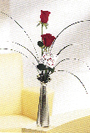 two red roses in a metal keepsake bud vase