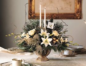 christmas arrangement with white flowers, christmas greens in 		a wire basket with glass bowl