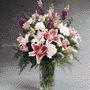 Vase arrangement Larkspur, Roses, Alstroemeria and Star Gazer 
Lilies.