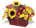 fall arrangement filled with flowers such as fall mums, alstroemeria, and yellow aster.