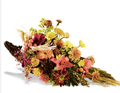 fall arrangement filled with flowers such as fall mums, alstroemeria, and yellow aster.